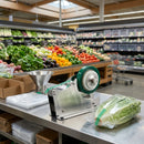 Stainless steel vegetable binding machine by Deal Online NZ, a manual tying tool for supermarket use with metal clips and handles.